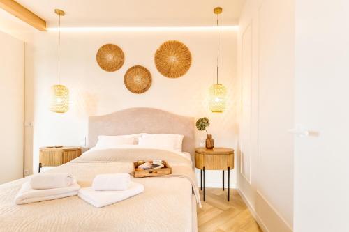 a bedroom with a bed with two towels and two tables at Wino&Grono Nałęczów in Nałęczów