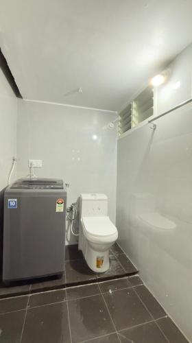 a small bathroom with a toilet in a room at Casa Red Homestay in Chikmagalūr