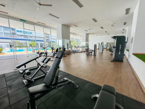 a gym with treadmills and exercise equipment in a building at Palmyra residence New condo in Kajang