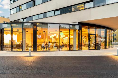a large glass building with people inside of it at harry's home Salzburg in Salzburg