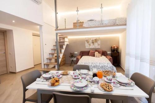 a room with a dining table and a loft bed at Casa Imperati in Agerola