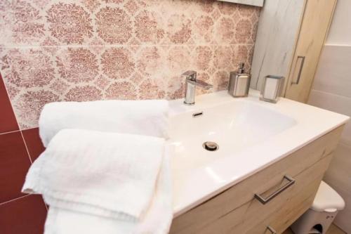 a bathroom with a sink and a toilet with towels at Casa Imperati in Agerola