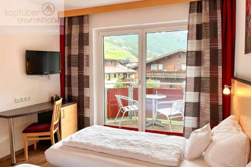 a bedroom with a bed and a window with a table at Sporthotel Bergheim in Sölden