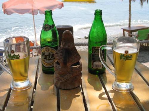 a table with two bottles and two glasses of beer at The Corsair Cottage in Kalymnos