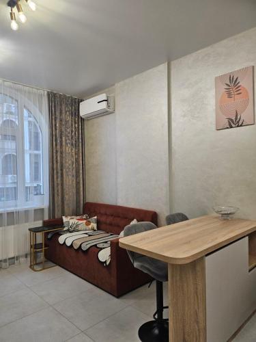 a living room with a couch and a table at Avinion 2 Апартаменты у моря in Odesa
