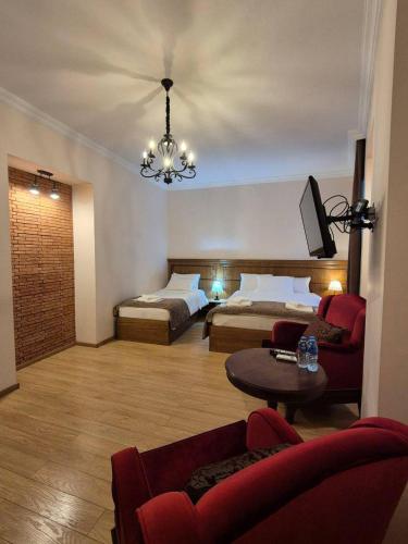 pokój hotelowy z dwoma łóżkami i żyrandolem w obiekcie B&B rooms w mieście Tbilisi City