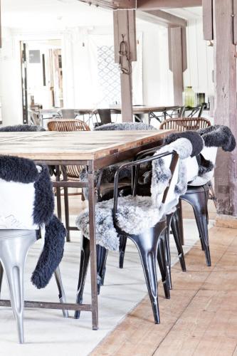 a wooden table and chairs with knitted chairs around it at Siggesta Gård in Värmdö