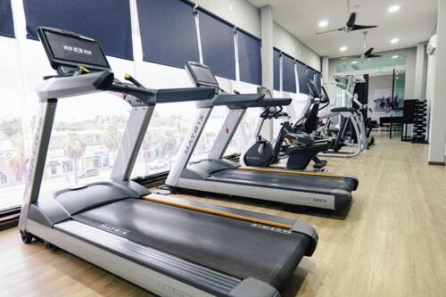 a gym with three treadmill machines in a room at Esplendor by Wyndham Los Mochis Country Place in Los Mochis