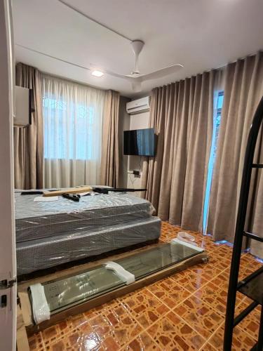 a bedroom with a bed and a tv in it at Aqua Aura 2 Bedroom Apartment Pereybere in Pereybere