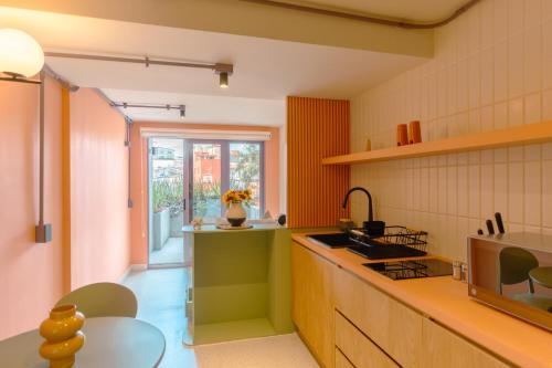 a kitchen with a sink and a counter top at Nico Hotel & Residences in Xalapa