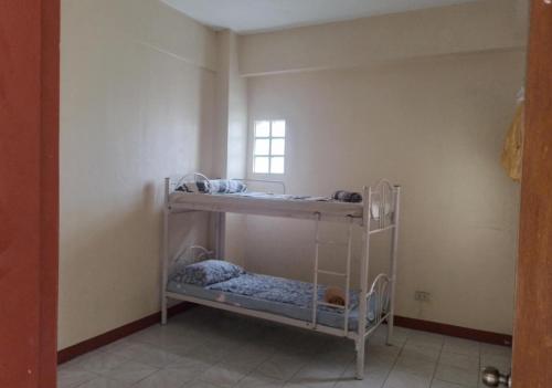 two bunk beds in a room with a window at Domizil Suites in Batangas City