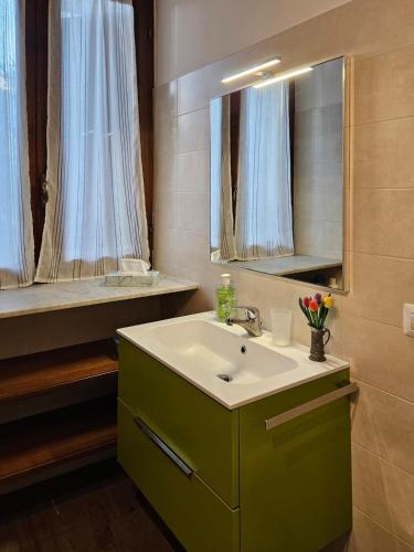 a bathroom with a sink and a mirror at La Corte dei Nonni in Vanzaghello