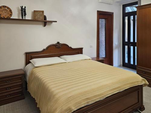a bedroom with a large bed and a window at La Corte dei Nonni in Vanzaghello