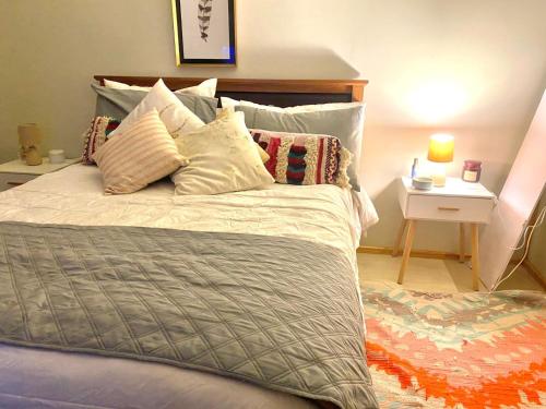 a bed with pillows on it in a bedroom at Loft independiente Casa Altavista in Valparaíso