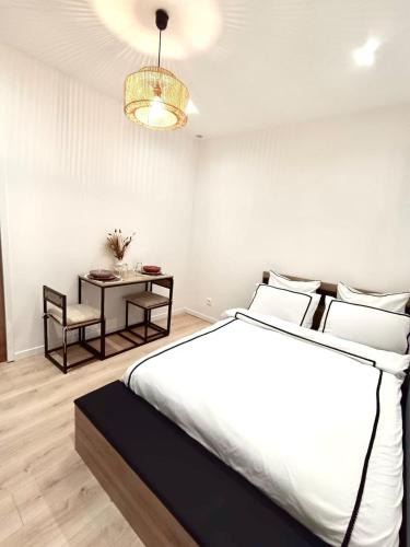 una camera da letto con un letto grande e un tavolo di Studio Luz a Bois-Colombes