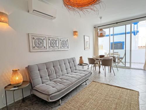 a living room with a couch and a dining room at Casa Alice - Olhão By Junto ao Mar in Olhão