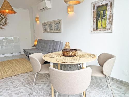 a living room with a table and chairs and a couch at Casa Alice - Olhão By Junto ao Mar in Olhão