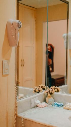 a bathroom with a sink and a mirror at San Pedro Hotel in Río Ceballos