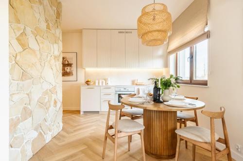 a kitchen and dining room with a table and chairs at Wino&Grono Nałęczów in Nałęczów