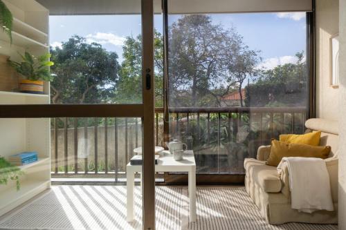 a living room with a view of a balcony at Baía II by An Island Apart in Funchal