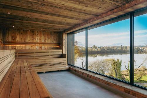 a sauna with a view of a lake at Best Western Plus Le Roi Arthur Hôtel & Spa in Ploërmel