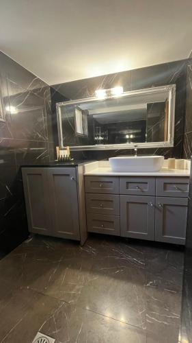 a bathroom with a sink and a mirror at Anasa house in Symi