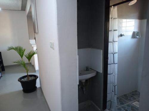 a white bathroom with a sink and a toilet at TN apartments voism in Diani Beach
