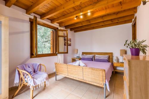 a bedroom with a bed and a table and chairs at Μeropi & Natalia Villas in Skopelos Town