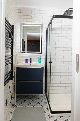 a bathroom with a blue sink and a mirror at Studio 104 le Graphite - Modern & Elegant in Bertrange