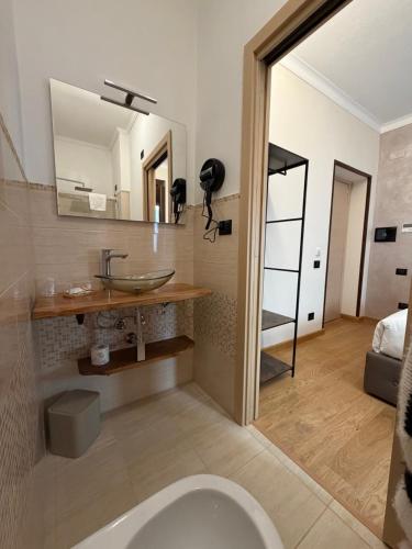 a bathroom with a sink and a toilet in a room at Le Stanze Del Duca in Ferrara