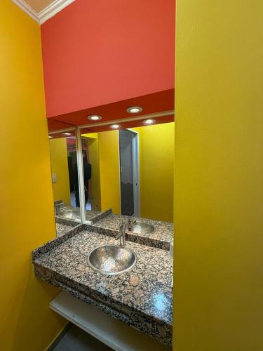 a bathroom with a sink in front of a mirror at Sendero Patagonico in Las Grutas