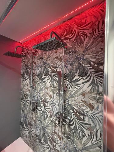 a shower stall with a mural of plants at CR Home in Palermo