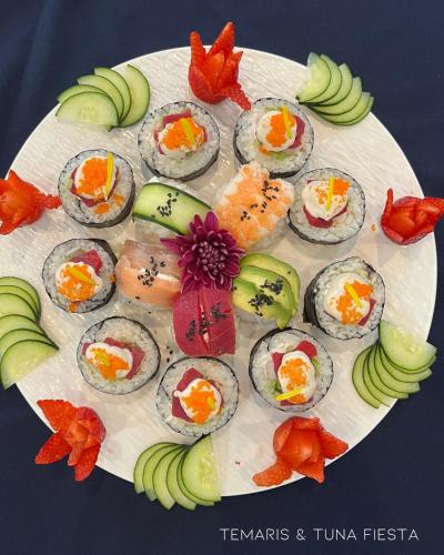 a plate of food with sushi and fruits and vegetables at Hotel La Ramonna Melaque in San Patricio Melaque