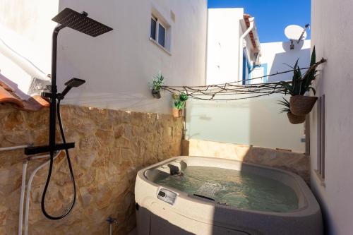 a bath tub in a bathroom with a shower at tiny BEACH HOUSES - 2 min to Beach in Salema