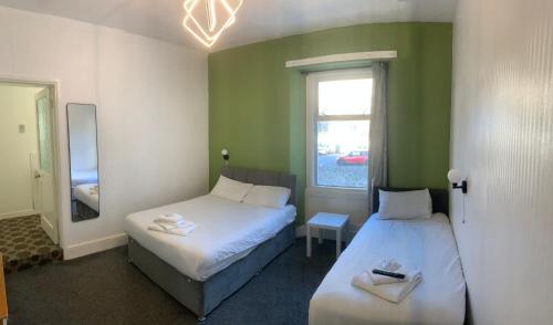 Ένα ή περισσότερα κρεβάτια σε δωμάτιο στο Savoy Hotel