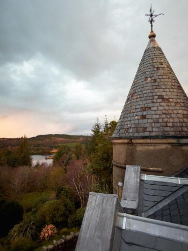 a church roof with a cross on top of it at Glencruitten House in Oban