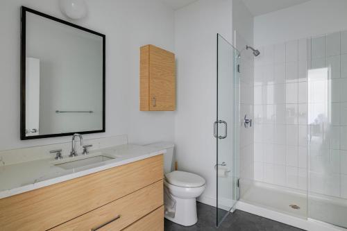 a bathroom with a sink and a toilet and a shower at Blueground Newtonville rooftop nr Newton Centre BOS-1233 in Newton