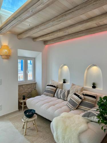 a living room with a couch and a table at tiny BEACH HOUSES - 2 min to Beach in Salema