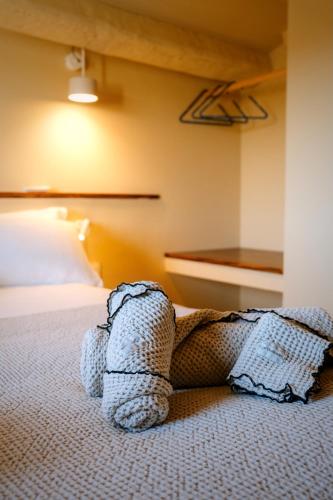 a bed in a hotel room with a pillow on the floor at Hotel Boutique CaLagneta - Art i Vi in Cervera
