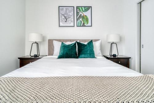 a bedroom with a large bed with green pillows at Blueground Hunter Mill District pool nr Lake Anne WDC-844 in Reston