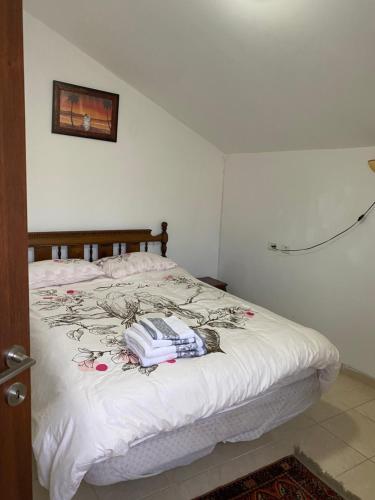 a bedroom with a bed with a phone on it at A beautiful apartment in Karmiel in Karmiel