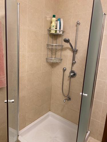 a shower with a glass door in a bathroom at A beautiful apartment in Karmiel in Karmiel