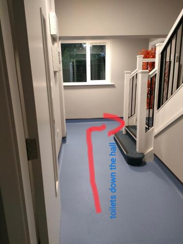 a hallway with a red line on the floor at Direct Travel Stays in Cork