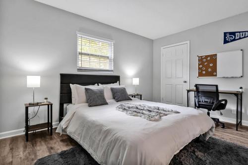 a bedroom with a large bed and a chair at Pet Friendly Duke 1br - Near Hospital and Downtown in Durham