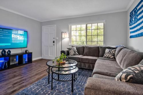 a living room with a couch and a table at Pet Friendly Duke 1br - Near Hospital and Downtown in Durham