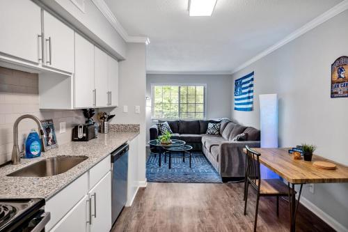 a kitchen and living room with a couch and a table at Pet Friendly Duke 1br - Near Hospital and Downtown in Durham