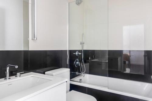 a bathroom with a white sink and a shower at Blueground Upper West Side pool nr Central Park NYC-1960 in New York