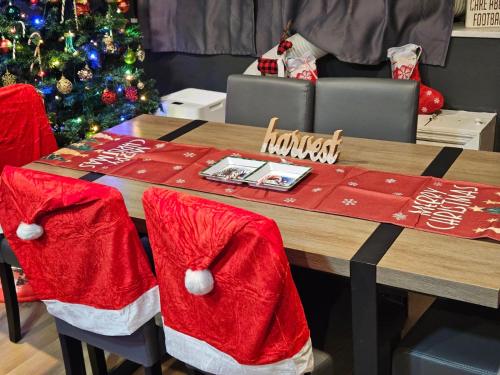 a table with santa hats on it with a christmas tree at Lux 2BR Condo with King Beds DTWN in Atlanta