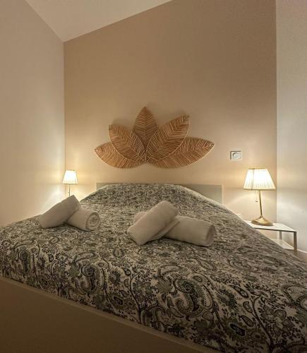 a bedroom with a bed with two pillows on it at Le 37 FOCH in Orange