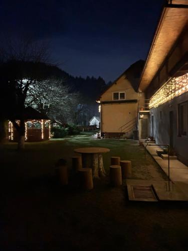 a table in the yard of a house at night at Insieme in Vidra